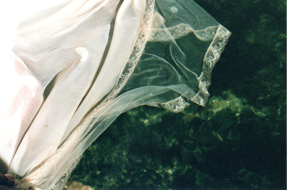 lacy fabric swirling in a river's current.