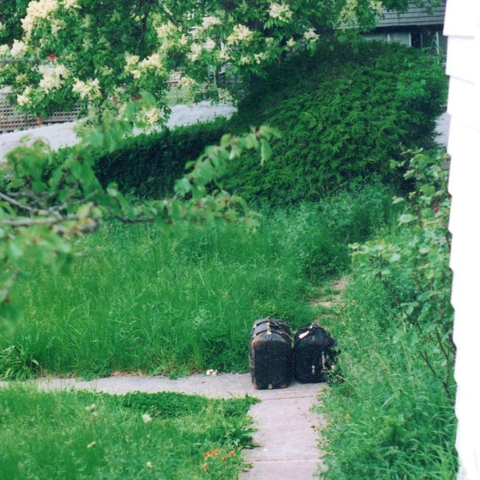 A small black suitcase sitting at the end of a walkway.